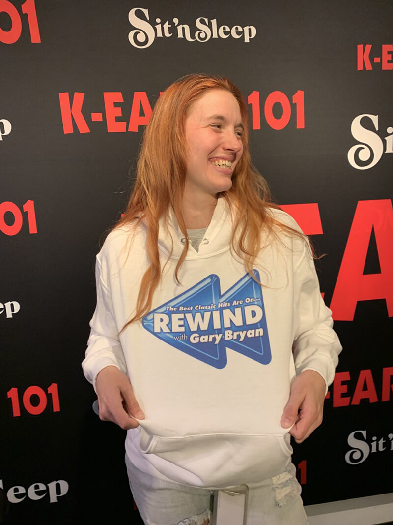 Photo of CRYSTAL ZAHLER wearing a white hoodie with a REWIND logo.