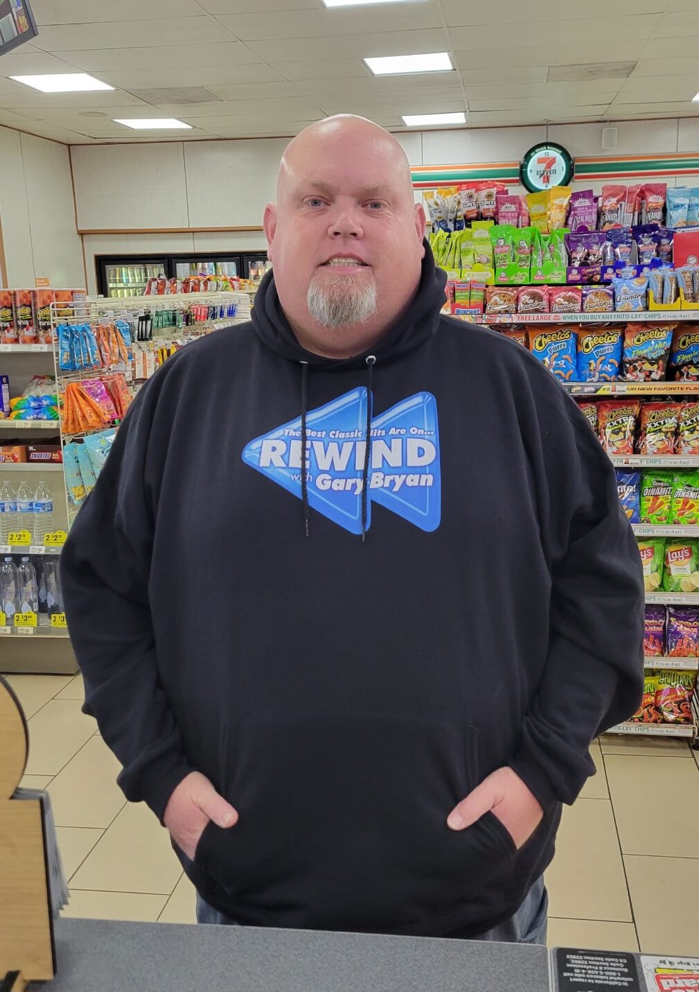 Man wearing a black Rewind show hoodie